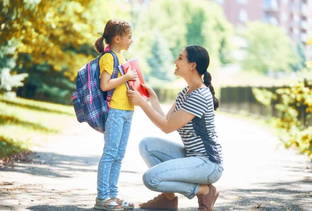 Mom sending her daughter off to school organized.